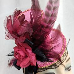 Steampunk pink velour mini top hat Fascinator decorated with pink and gold trims, roses, ribbons, lace, and feathers.  It features an arrangement comprising a pink velvet rose, organza and satin flower, black lace, pink coque tail feathers, and black & pink tiger tuft feathers.  Great accessory for a day at the races or a tea party.  It holds to the head with a black elastic band. Place the elastic at the back of your head under your hairline. Handmade in Australia. Laura Lucci's Collection Vintage Pink Fitted Fascinator, Pink Adjustable Mini Hat For Costume Party, Pink Mini Hat For Festivals, Pink Adjustable Costume Accessories For Costume Party, Adjustable Pink Costume Accessories For Costume Party, Adjustable Pink Carnival Hat, Vintage Mini Hats With Feathers For Party, Vintage High Crown Mini Hat For Parties, Pink Adjustable Costume Hat For Carnival