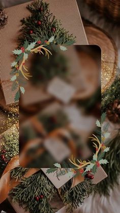 a christmas card with holly and pine cones on it, surrounded by other holiday decorations