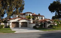 a large house with two garages on the street