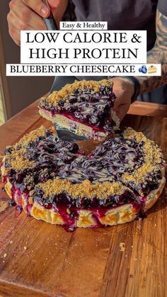 a blueberry cheesecake on a wooden cutting board with the title low calorie & high protein blueberry cheesecake