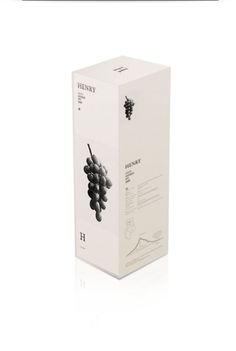 a white box with some black grapes in it on a white surface and the packaging is empty