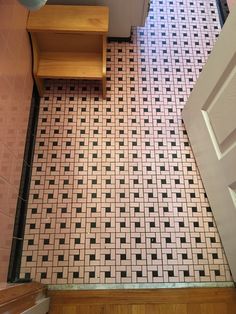 a bathroom with black and white tiles on the floor