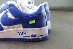 Embrace iconic style with these statement-making sneakers inspired by the legendary Louis Vuitton x Nike Air Force 1 collaboration. The vibrant blue leather upper, accented with the signature Louis Vuitton monogram, exudes luxury and street-style cool. Off-White™-inspired details add a contemporary edge, like the quoted "AIR" branding and exposed stitching. Step into the spotlight with these coveted kicks that blend high-fashion and sneaker culture. Your order arrives in a branded shoe box, comp Custom Lace-up Sneakers For Streetwear With Logo, Blue Lace-up Sneakers With Logo Print, Blue Leather Sneakers With Logo Print, Designer Logo Sneakers For Streetwear, Blue Lace-up Sneakers With Logo, Blue Sporty Sneakers With Logo, Luxury Logo Print Sneakers For Streetwear, Blue Logo Sneakers For Streetwear, Blue Leather Sneakers With Logo