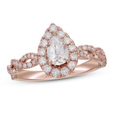 a rose gold engagement ring set with an oval cut diamond surrounded by small round diamonds