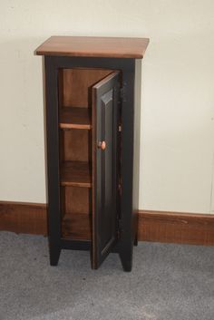 a small wooden cabinet with an open door