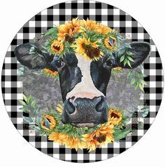 a black and white cow with sunflowers on it's head in a circle