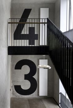 the stairs are painted black and white with numbers on them in this modern apartment building