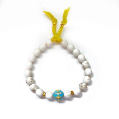 Handcrafted one-of-a-kind white matte turquoise gemstone bracelets, turquoise enamel center ball with pave diamonds, a silk velvet ribbon with vintage brass danglers. Wear this chic bracelet set alone or stacked other bracelets. Note: Priced as a set or just a single one. Matte white Turquoise gemstones Enamel and pavé diamonds Bracelet measures 7" inches Made with love in Los Angeles Complimentary gift wrapping provided All sales final. Turquoise And Pink Bracelet, Blue Turquoise Oval Bracelet, White Howlite Bohemian Bracelets, White Howlite Bohemian Bracelet, White Bohemian Howlite Bracelet, Elegant Adjustable Howlite Jewelry, Hand-strung Turquoise Crystal Round Bracelet, Bohemian Turquoise Hand-strung Bracelets, Elegant Turquoise Multi-stone Bracelets