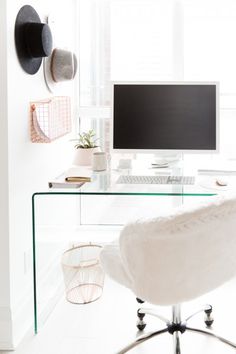 a glass desk with a computer on it