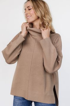 Cozy up with this darling pullover! Light mocha brown hue Soft sweater-knit material Mock neckline Long sleeves with drop shoulder Exposed seam detail at front and back bodice Ribbed at collar, sleeve cuffs, and hem Split sides at bottom hem Comfortable fit 75% Acrylic, 25% Polyester Trina is 5'6, cup size 32D, size 2 and is wearing size S Beige Turtleneck Sweater With Ribbed Neckline, Brown Knit Sweater With Ribbed Neckline, Neutral Knit Tops For Winter, Brown Winter Loungewear Tops, Cozy Neutral Top For Fall, Brown Loungewear Tops For Winter, Knit Funnel Neck Tops For Fall, Fall Knit Funnel Neck Tops, Fall Knit Tops With Funnel Neck