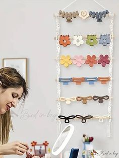 a woman looking through a magnifying glass in front of a display of hair clips