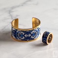 This beautiful Cuff Bracelet and Ring set is a true testament to the artisanal traditions of Tunisia. The intricate designs and patterns of the set are inspired by the country's rich history of mosaics, and the skilled artisan who crafted this set has brought this tradition to life in a truly stunning way. Whether you're looking to add a pop of color to your outfit or simply want to celebrate the vibrant and colorful traditions of Tunisia, this Cuff Bracelet and Ring set is sure to impress. With Bracelet And Ring Set, Bracelet And Ring, Blue Mosaic, Cuff Ring, Cuff Rings, Mosaic Designs, Intricate Designs, Cultural Heritage, Tunisia