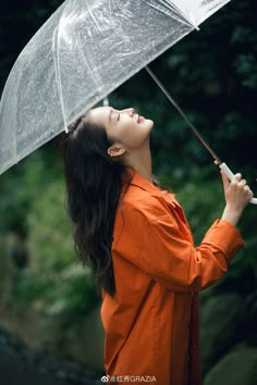 a woman holding an umbrella in the rain