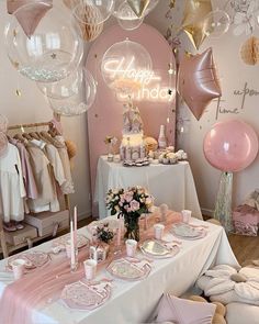 a room filled with lots of pink and white balloons