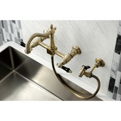 a kitchen sink with two faucets on the side and a marble counter top