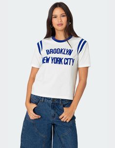 This Trendy T-Shirt Will Have You Reppin New York Like You're A Local. With It's Perfectly Cropped Fit And Cute Contrast Detailing, It's A Great Option For A Casual Comfy Fit. T-Shirt. Contrast Neckline. Stretchy Shoulder Stripe Detailing. Velvet Text. 95% Cotton, 5% Spandex. Model Wears Size S. Model Height Is 5'7. Item Care: Machine Wash At Maximum 30ºc, Do Not Bleach, Tumble Dry Low, Iron At A Maximum Of 110ºc, Do Not Dry Clean. | Edikted New Yorker Tee Visionary Fashion, Swimwear Dress, Top Graphic Tees, Trendy Tshirts, Pant Shirt, Cut Shirts, Skirted Swimwear, Short Rompers, Hoodie Dress