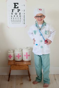 Doctor Costume w/ Accessories The doctor is in! Look the part in this complete ensemble as you diagnose and treat pretend patients with this 8 piece dress-up-and-play set. The set includes a white doctor's coat, green scrub pants, a green fabric mask, white hat, play stethoscope, play syringe, and play thermometer. The coat also features a sewn in doctor's name tag holder with removable name tag and Velcros on and off. All our Great Pretenders Career Costumes are packaged in a reusable blue garm Doctor Role Play, Career Costumes, Doctor Coat, Doctor Names, Doctor Costume, Green Scrubs, Pink Scrubs, Role Play Costume, Mask White