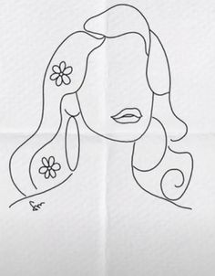 a drawing of a woman's face with flowers in her hair