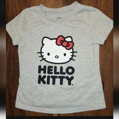 Nwot Girls Size 7 Hello Kitty By Sanrio Gray Short Sleeve T-Shirt. In Perfect Condition. I Also Have Many Other Clothing Listings And Lots And Am Willing To Mix And Match, Combine, Sale Individual Pieces From Lots, Etc. Just Make An Offer! Check Out My Other Listings! Cute Fitted Hello Kitty T-shirt, Fitted Hello Kitty Print Cute T-shirt, Fitted Cute Hello Kitty T-shirt, Fitted Cute T-shirt With Hello Kitty Print, Fitted Cotton T-shirt With Hello Kitty, Disney Tshirts, Girls Tees, Cat Shirts, Grey Shorts