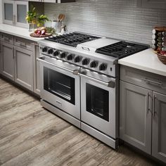 a stove top oven sitting inside of a kitchen next to an oven and countertop