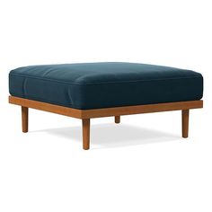 a blue ottoman sitting on top of a wooden frame