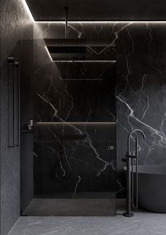 a black and white bathroom with marble walls