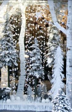 the window is decorated with snow and trees