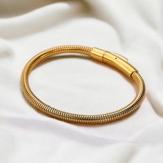 ✨ Gold Bangle Bracelet ✨ Introducing our exquisite Gold Bangle Bracelet, crafted for timeless elegance and versatility. Ideal as a gift for her, bridesmaids, weddings, or birthdays, this minimalist accessory enhances any outfit with its sophisticated design. Elevate your style with this must-have piece of personalized jewelry. ✨FREE DELIVERY✨  ✨What's Included: 1x 18k Gold styled Stainless Steel Gold Bangle Bracelet (6cm x 0.4cm) ✨M A T E R I A L✨ Stainless Steel  ✨S I Z E✨ 6cm x 0.4cm  10.0g *- Adjustable Snake Chain Bracelet For Everyday, Adjustable Jubilee Snake Chain Bracelet, Flexible Metal Jewelry As A Gift, Gold-colored Stainless Steel Wedding Bracelet, Stainless Steel Jubilee Bangle As Gift, Elegant Snake Chain Charm Bracelet For Gift, Adjustable Chain Bangle As A Gift, Gold Bracelets With Lobster Clasp For Wedding, Minimalist Flexible Chain Bracelet As Gift