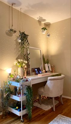 a room with a desk, mirror and plants