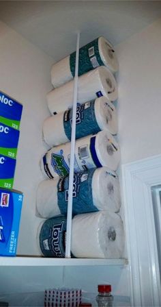 several rolls of toilet paper are stacked on top of each other in a bathroom shelf