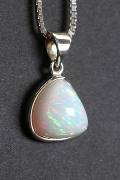 Welo Opal Pendant Approx. Dimensions: 18x15x10 mm This pendant is made with .925 Sterling Silver. Chain is not included. Welo Opal, also known as Ethiopian Opal, is a stunning and highly prized variety of opal that originates from the Wollo Province in Ethiopia. It has gained significant attention in the gemstone world due to its vibrant play-of-color, which rivals that of other well-known opals like Australian Opal.One of the defining characteristics of Welo Opal is its exceptional play-of-colo Hallmarked Ethiopian Opal Pendant Jewelry, Collectible Opal Jewelry Hallmarked, Collectible Hallmarked Opal Jewelry, Polished Opal Pendant Jewelry, 925 Sterling Silver Chain, Australian Opal, Welo Opal, Opal Pendants, Sterling Silver Chain