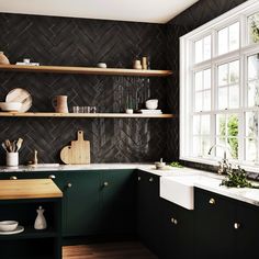 a kitchen with green cabinets and white counter tops, black backsplash tiles on the wall