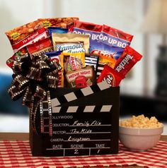 a movie themed gift basket on a table with a bowl of popcorn and film clapper