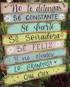 a wooden sign with spanish words on it