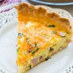 a slice of quiche on a white plate