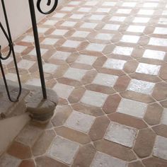 an image of a tiled floor with iron railings