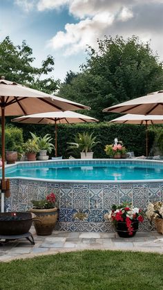 an outdoor pool with umbrellas and potted plants