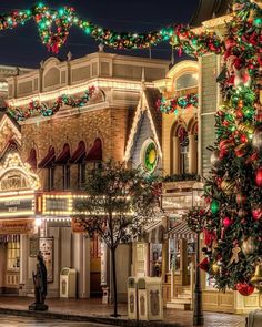 christmas lights adorn the front of a building on a street corner in an amusement park