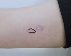 a small cloud tattoo on the arm