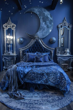 a blue bedroom with an ornate bed, mirror and moon decoration on the headboard