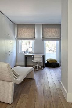 a living room filled with furniture and wooden floors