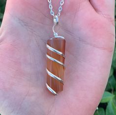 This listing is for a Spiral Wire Wrapped Carnelian Necklace. Carnelian is a transparent stone that has a pale orange to brownish red hue. This stone's hue comes from iron oxide and the color Carnelian was named after this mineral. It was discovered in ancient times before 1800 B.C. Carnelian translates from Latin to mean cornel cherry, like its color. Carnelian is thought to be a stone of the sun. It helps to restore the flow of positivity and energy within the body. This stone assists in sheltering the soul from depression and stabilizing fear within the mind, therefore, Carnelian represents Change & Stability. Sacred Chakra: The Sacred Chakra brings Enthusiasm & Rejuvenation to everyday life. When this Chakra is balanced it can bring Desire & Creativity. **Due to the unique nature of ea Luxury Orange Spiritual Necklaces, Luxury Spiritual Orange Necklace, Luxury Orange Spiritual Necklace, Sacred Chakra, Handmade Boho Jewelry, Crystal Point Necklace, Carnelian Necklace, Pale Orange, Moonstone Crystal