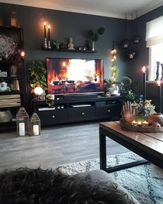 a living room filled with furniture and a flat screen tv sitting on top of a wooden table