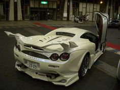 a white sports car parked on the street