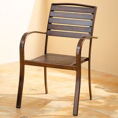 a wooden chair sitting on top of a tiled floor