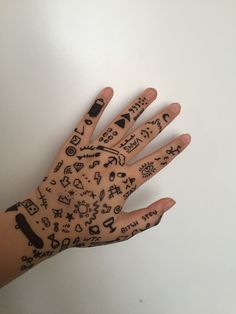 a person's hand with tattoos on it