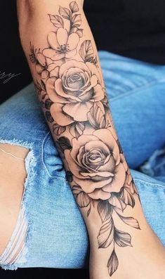 a woman's arm with flowers on it