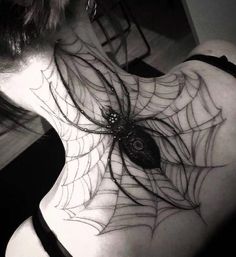 a woman with a spider web tattoo on her back