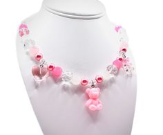 These are handmade, hand crafted beaded necklace with diamond beads and pink and white pearls, with three cute little charms attached with the necklace . These necklaces are for all ages, weather your a child who loves to play and be fashionable and have fun or a adult who loves cute and fun things! This fashion accessory will bring joy to you, especially for gifts !  These jewelry is locally made in Austin TX if you have any questions please feel free to contact us at our message board .  Fragi Cheap Pink Charm Necklaces, Cheap Pink Charm Necklaces With Heart Beads, Cheap Personalized Pink Beaded Necklaces, Pink Birthday Charm Necklace, Cheap Customized Pink Necklaces, Cheap Playful Pink Charm Necklaces, Affordable Playful Pink Charm Necklaces, Cheap Pink Beaded Charm Necklaces, Cheap Pink Necklaces With Pearl Charm