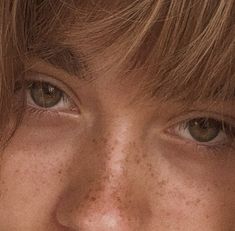 a close up of a person with freckles on their face